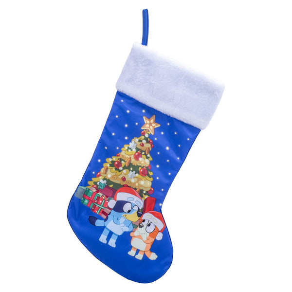 Kurt S. Adler Bluey™ and Bingo Wearing Santa Hats in Front of a Festive Christmas Tree on a Blue Stocking